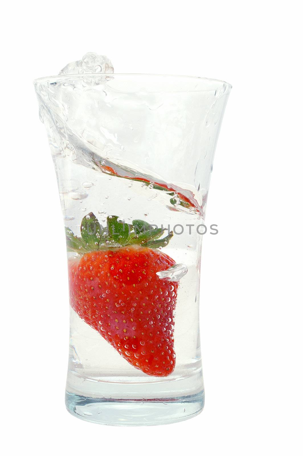 Big fresh strawberry in glas with bubble water isolated