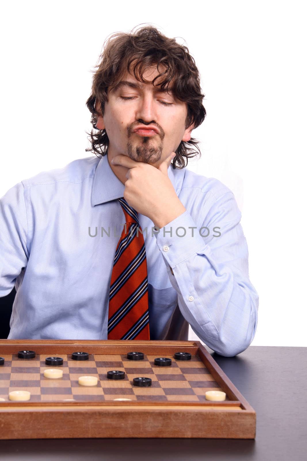 businessman playing chess against white background