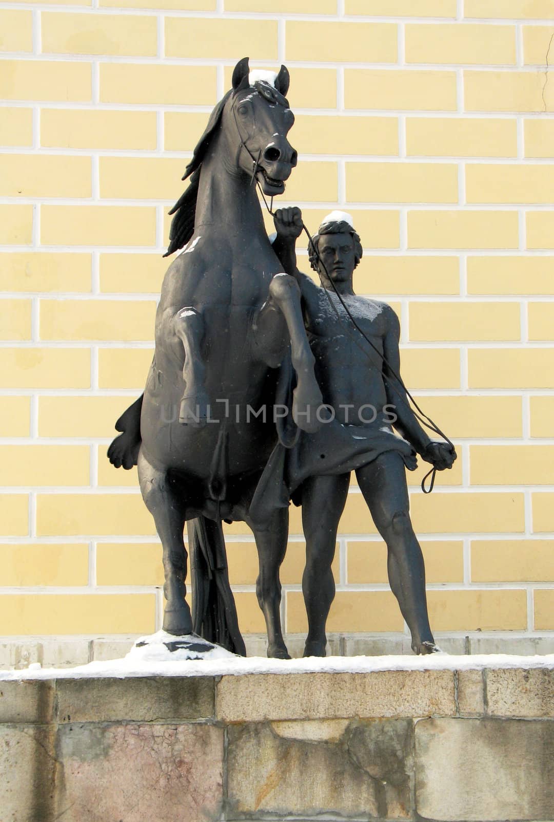 Statue of man and horse in a park in Moscow, Russia (winter)