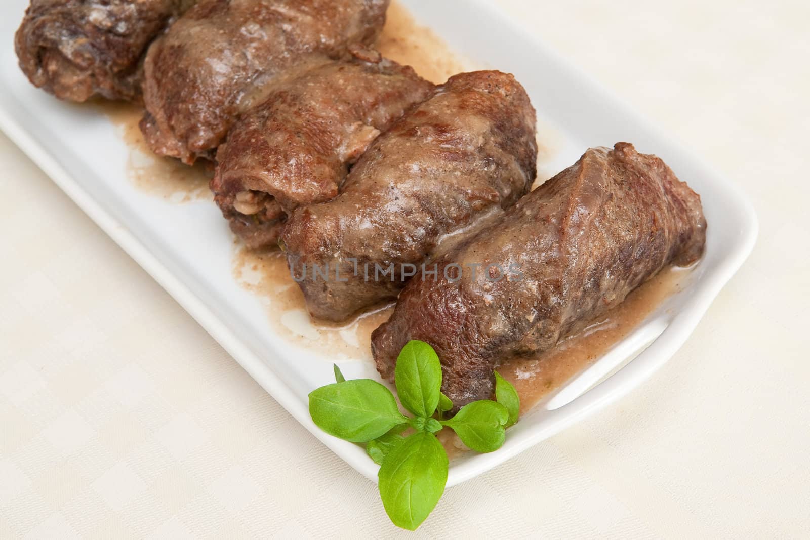 Rolled meat on the white plate