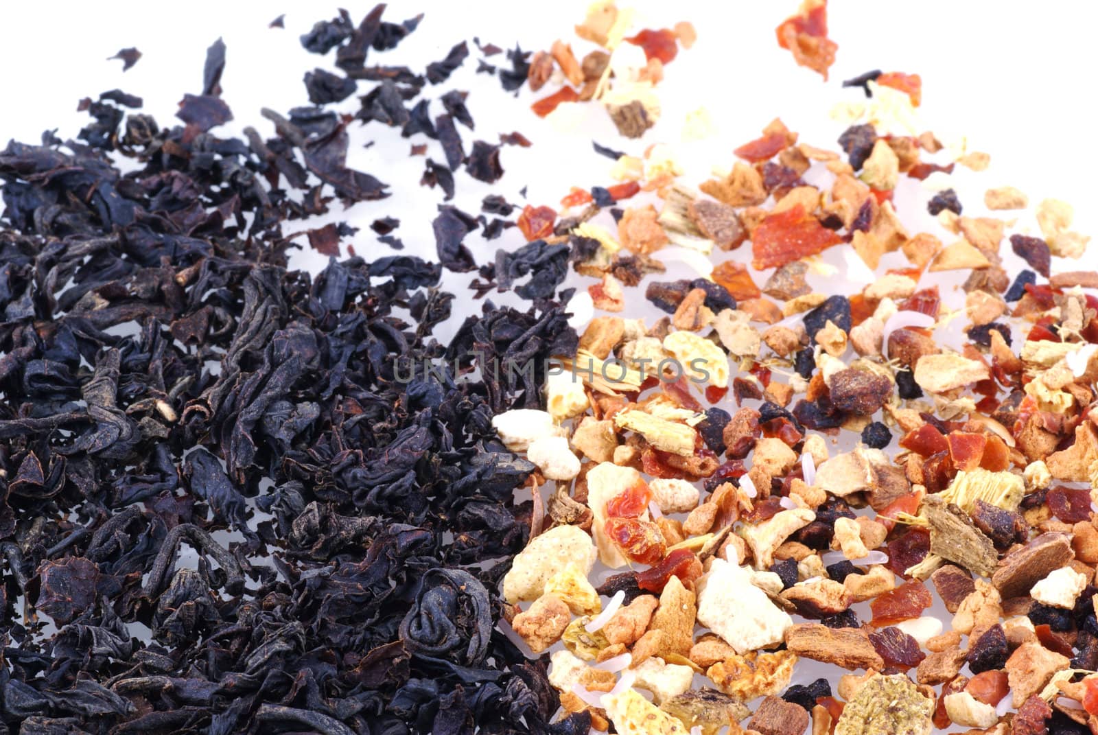 Close up of some black tea and some fruit tea, isolated on white.                