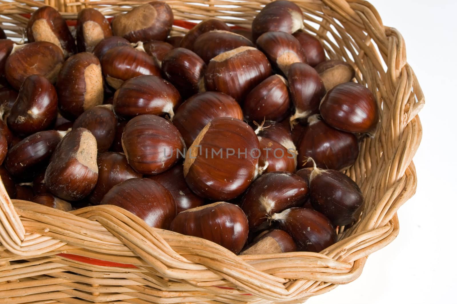 	wicker basket with chestnuts isolated on white background