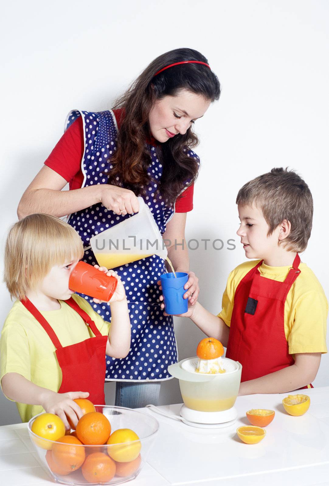 Children with mother drinking orange juice