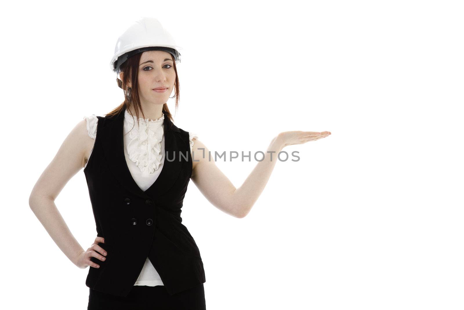Young business woman wearing a business suit and construction had holding her hand as if presenting something against a white background