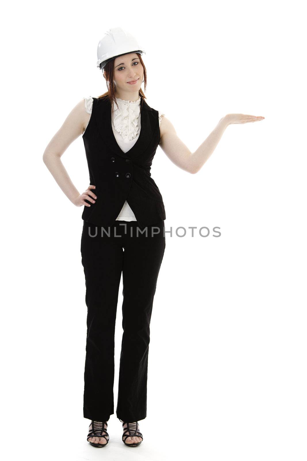 Young business woman wearing a business suit and construction had holding her hand as if presenting something against a white background