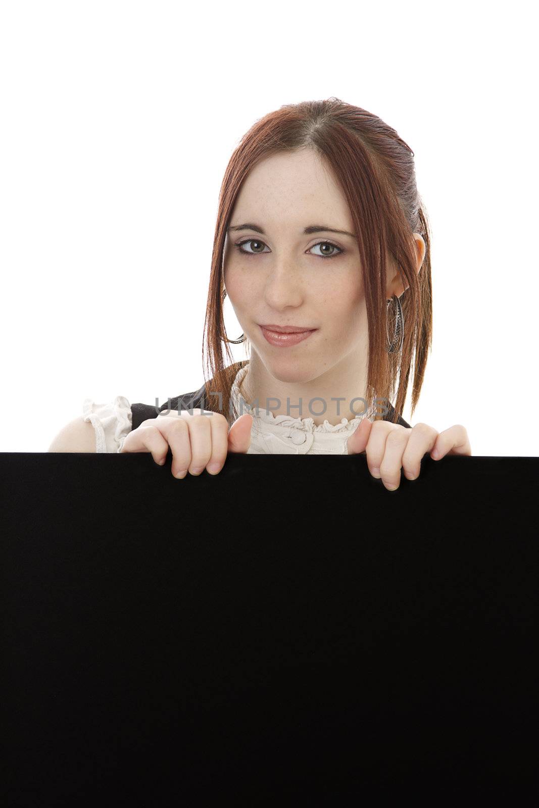 Young woman popin out from behing a black board