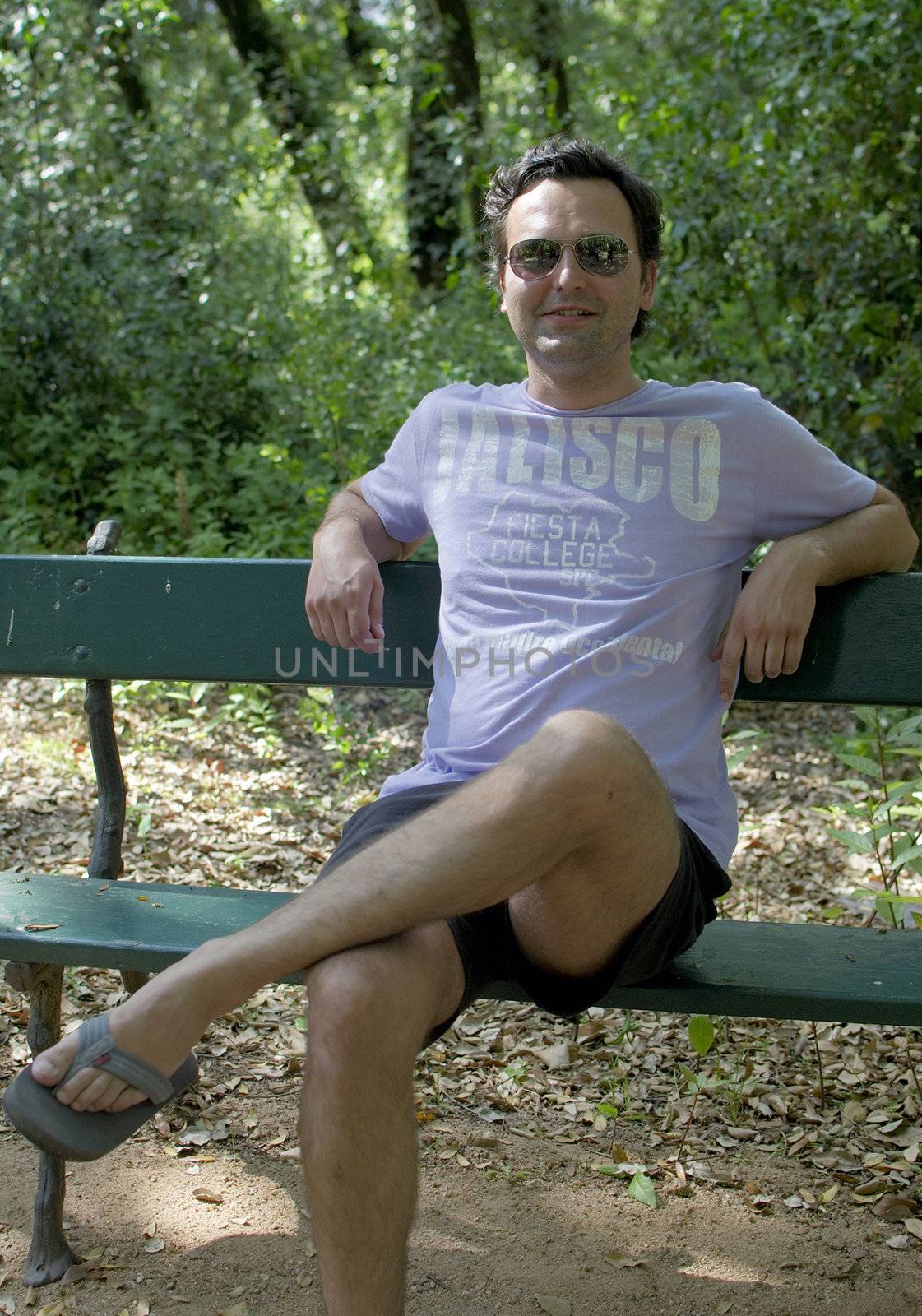 Men sitting on a garden bench in a Summer day