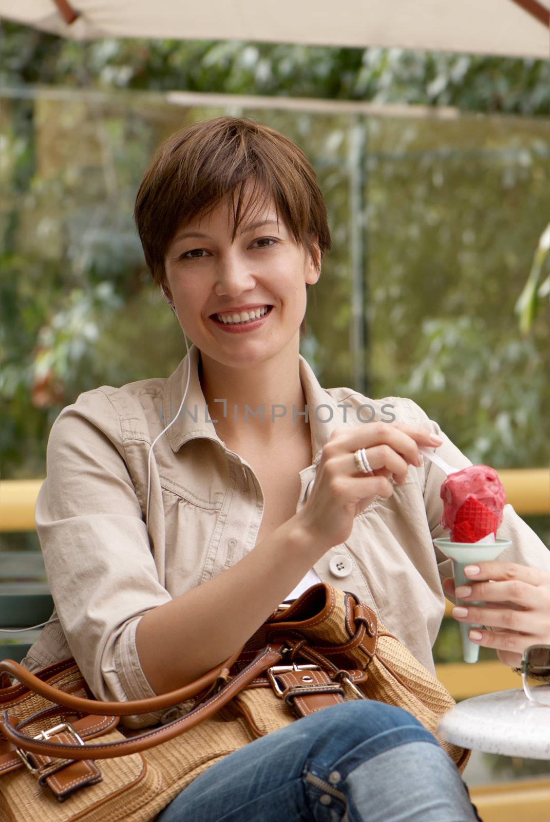The happy woman with fruit ice-cream 
