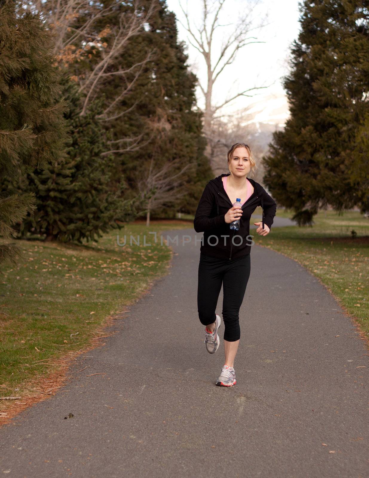 A jogger runs towards the viewer.  Plent of room for text.