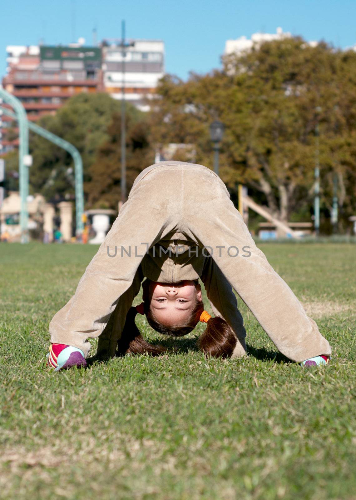 The girl playing a grass in park