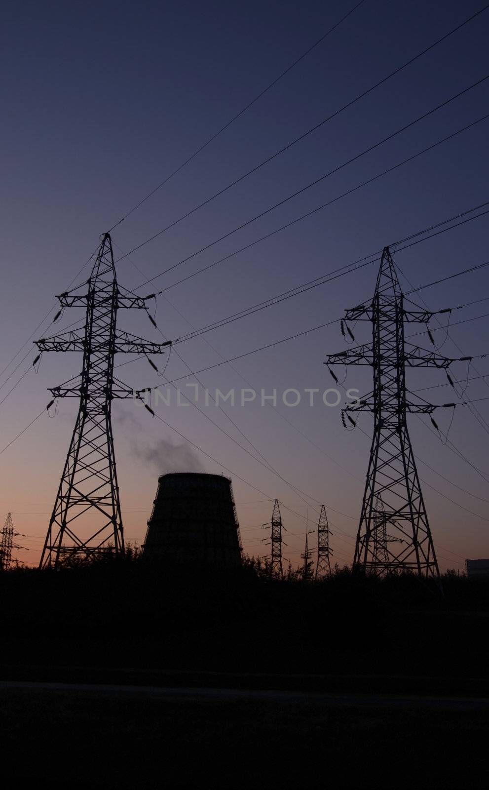 Power station over orange and blue sky