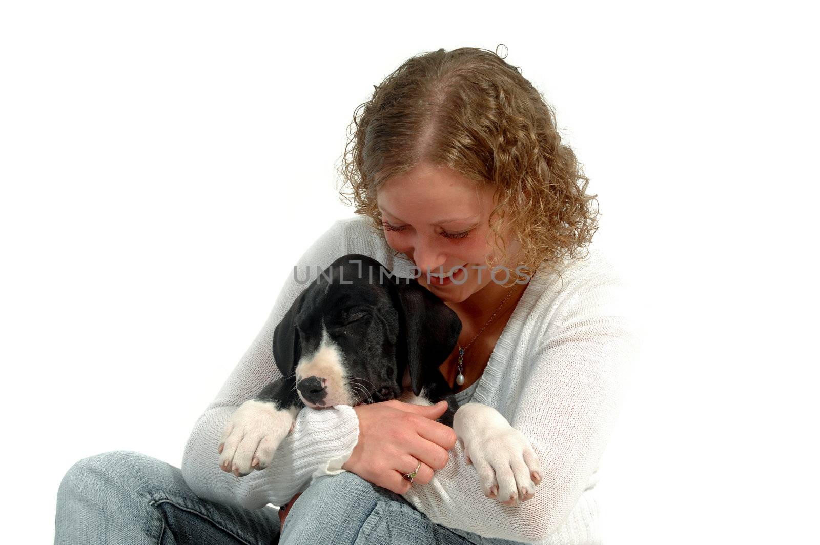 Young woman is holding a sleeping puppy. (Greate Dane)