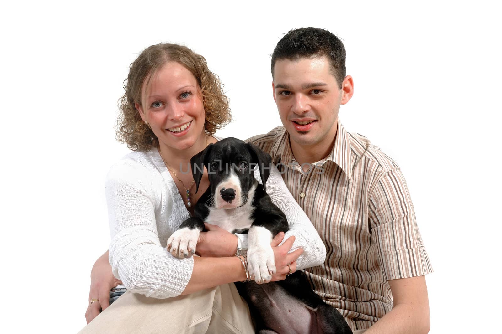 Portrait of a young couple and their sweet puppy.