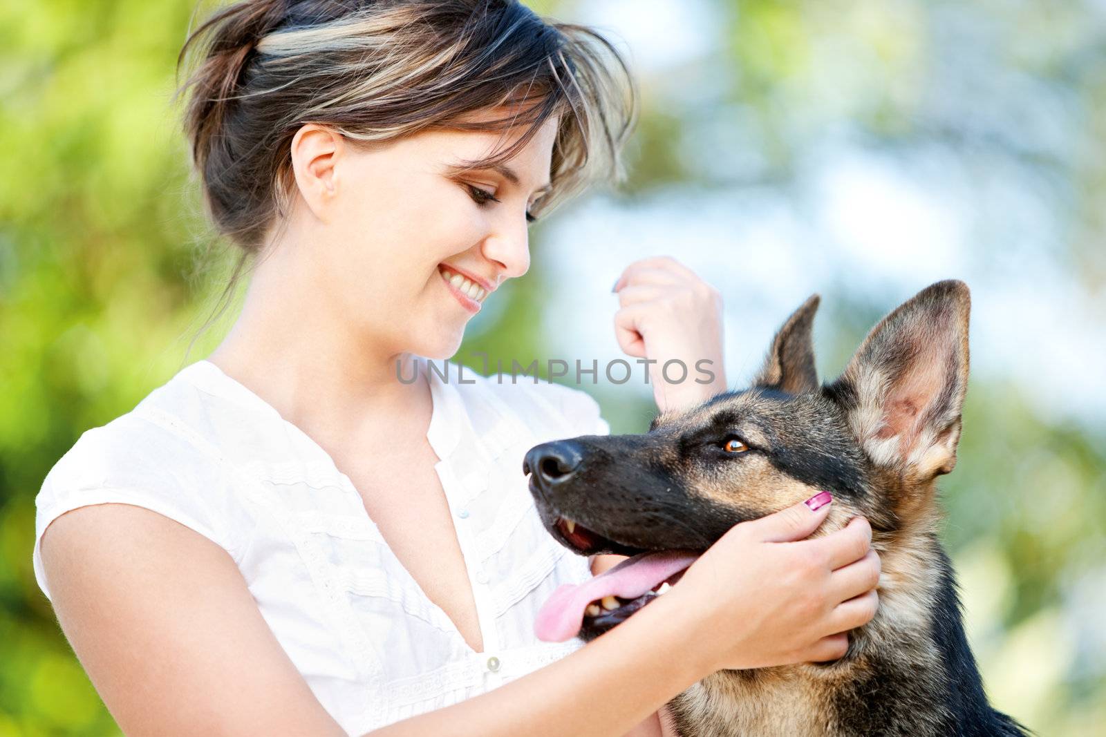 Young woman enjoying a sunny summer day with her dog