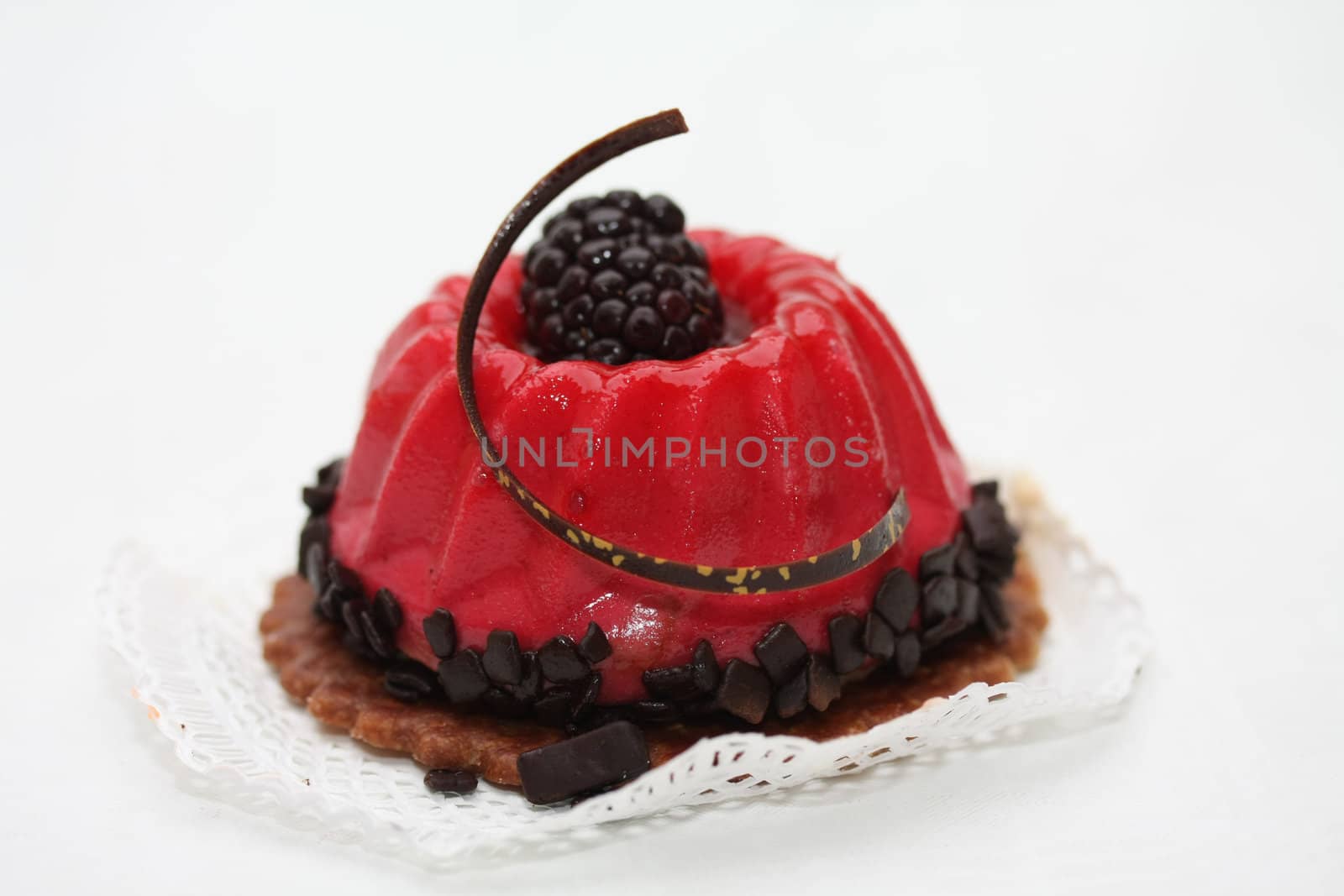 red fruitcake with chocolate and bramble decoration