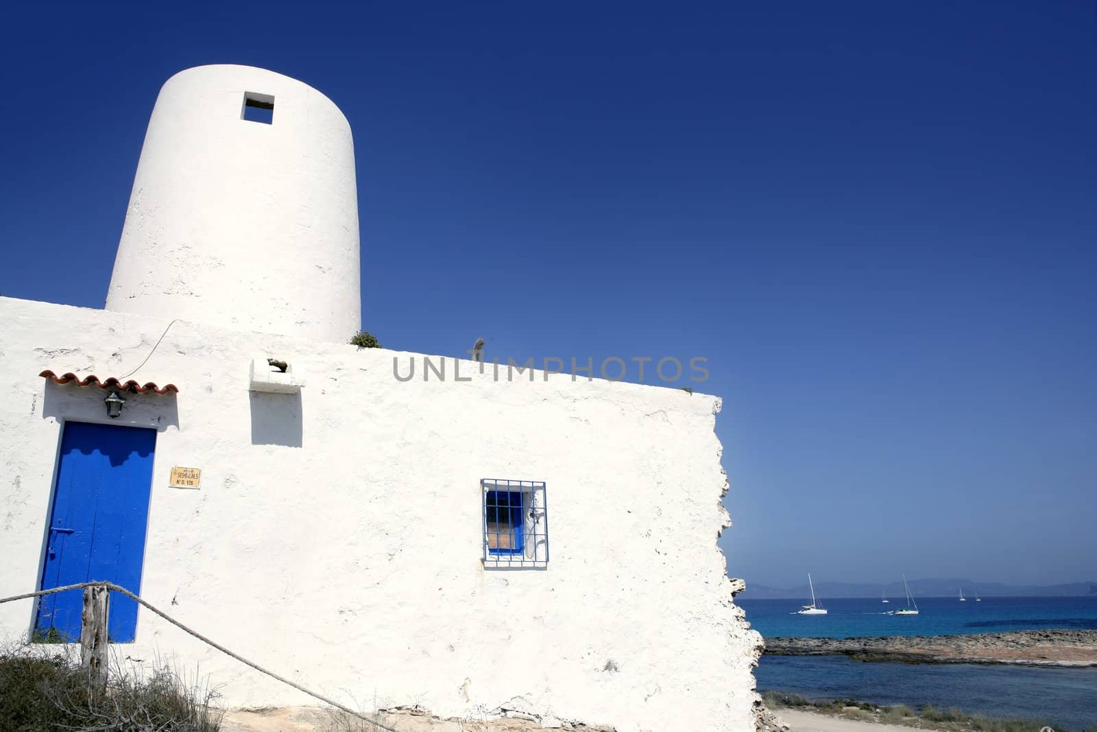 Balearic islands architecture white mill in Formentera over blue sky
