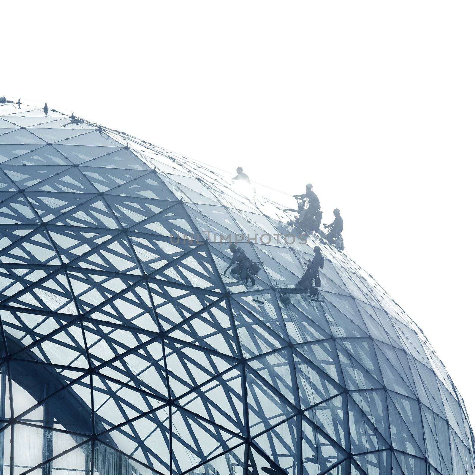 Workers cleaning a round glass facade by lunamarina