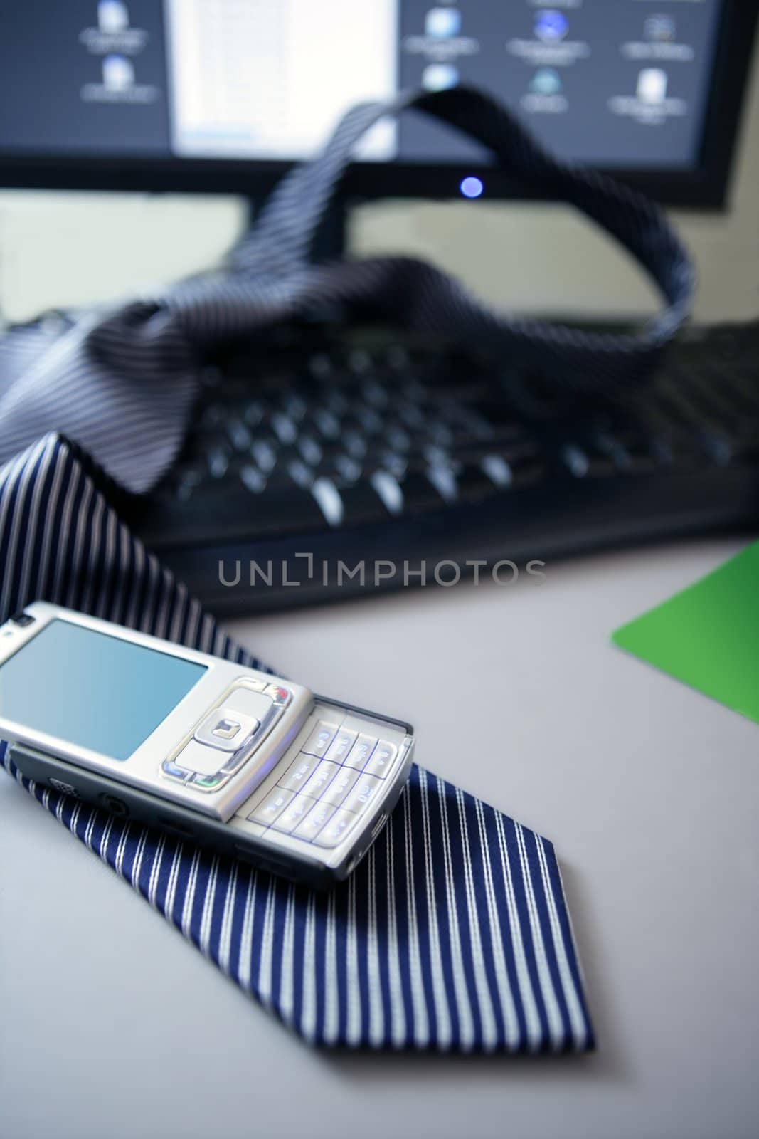 Businessman break, left his tie and phone over computer keyboard