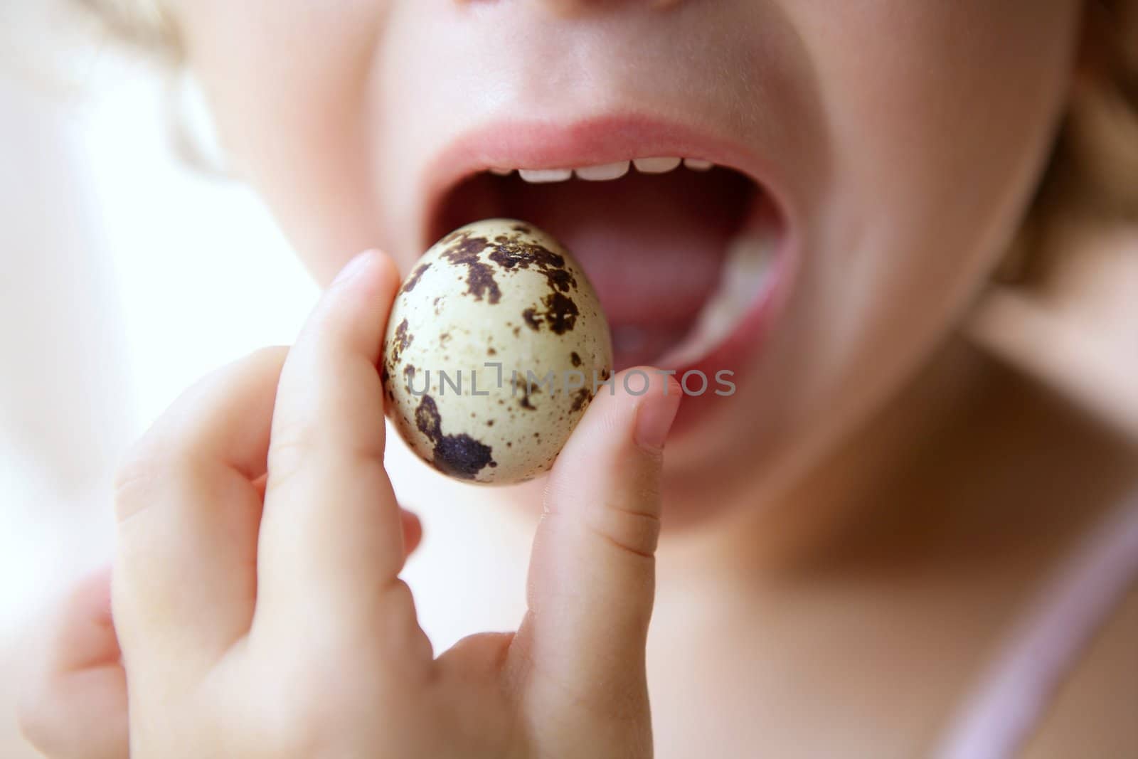 Little girl holding quail egg by lunamarina