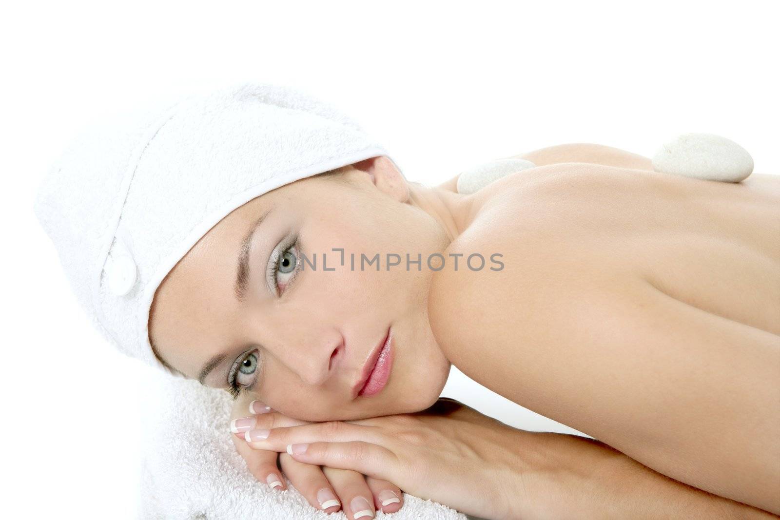Beautiful woman relaxed on spa with stone treatment by lunamarina