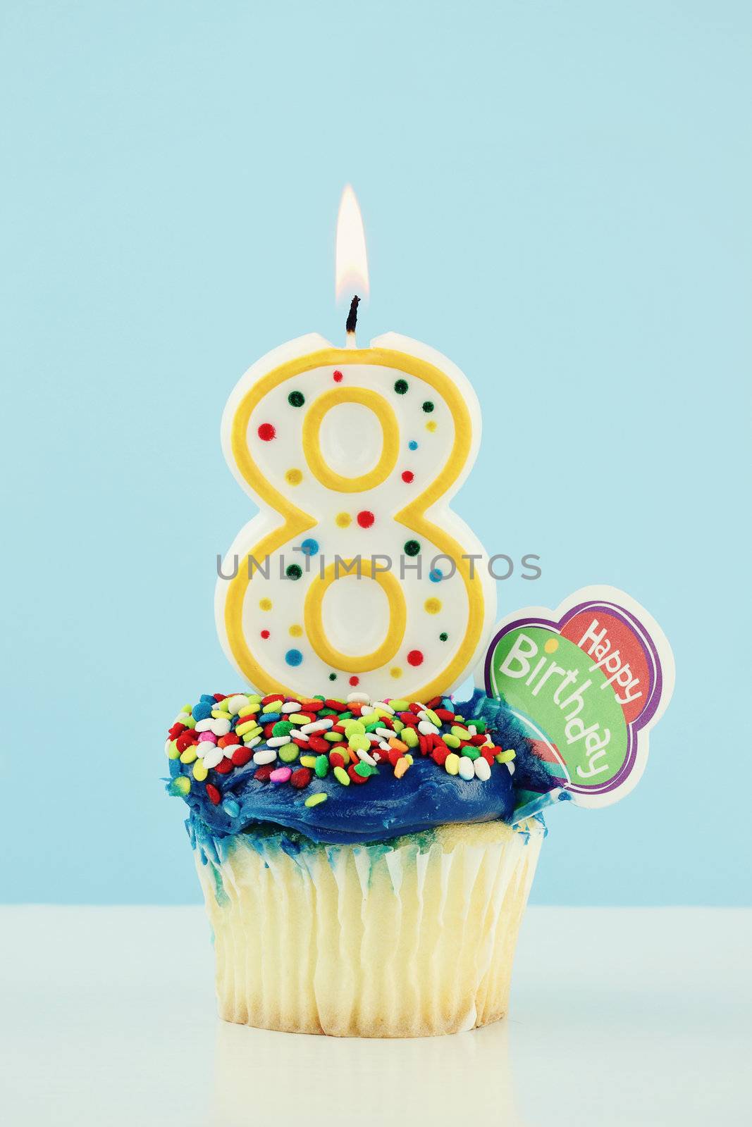 Birthday cupcake with a large number eight candle.