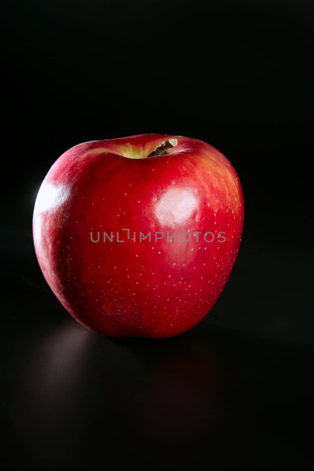 Apple red fruit isolated over black background