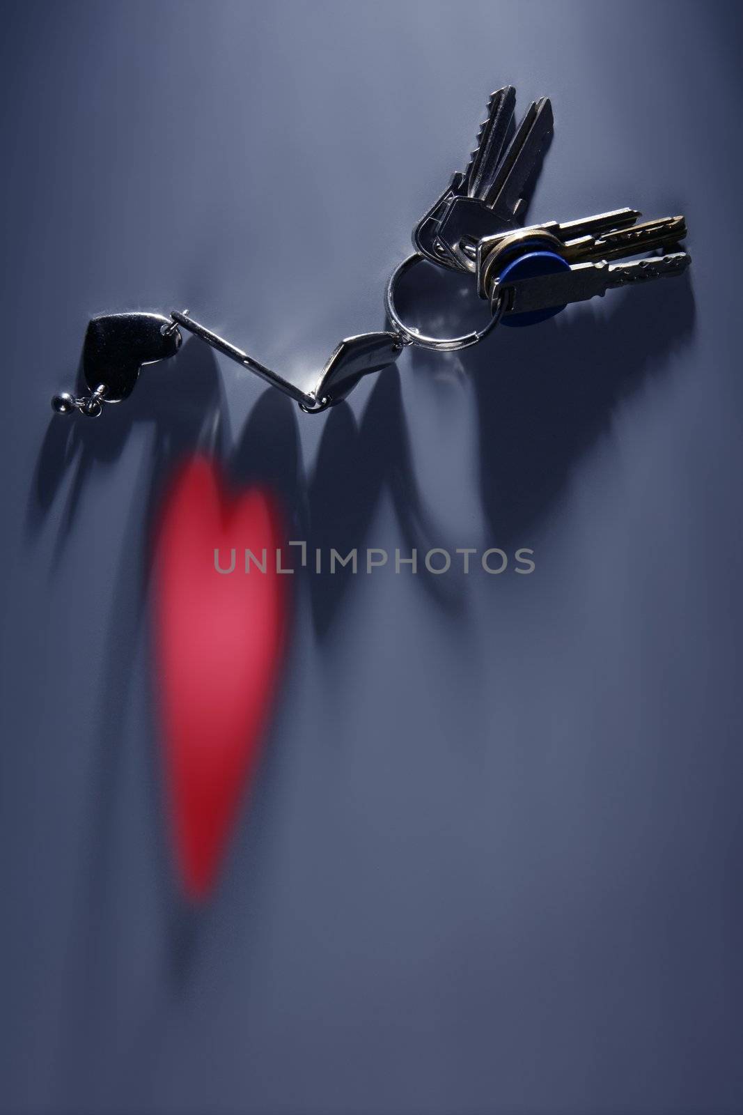 Real state mortgage metaphor, keys with red heart light on shadow