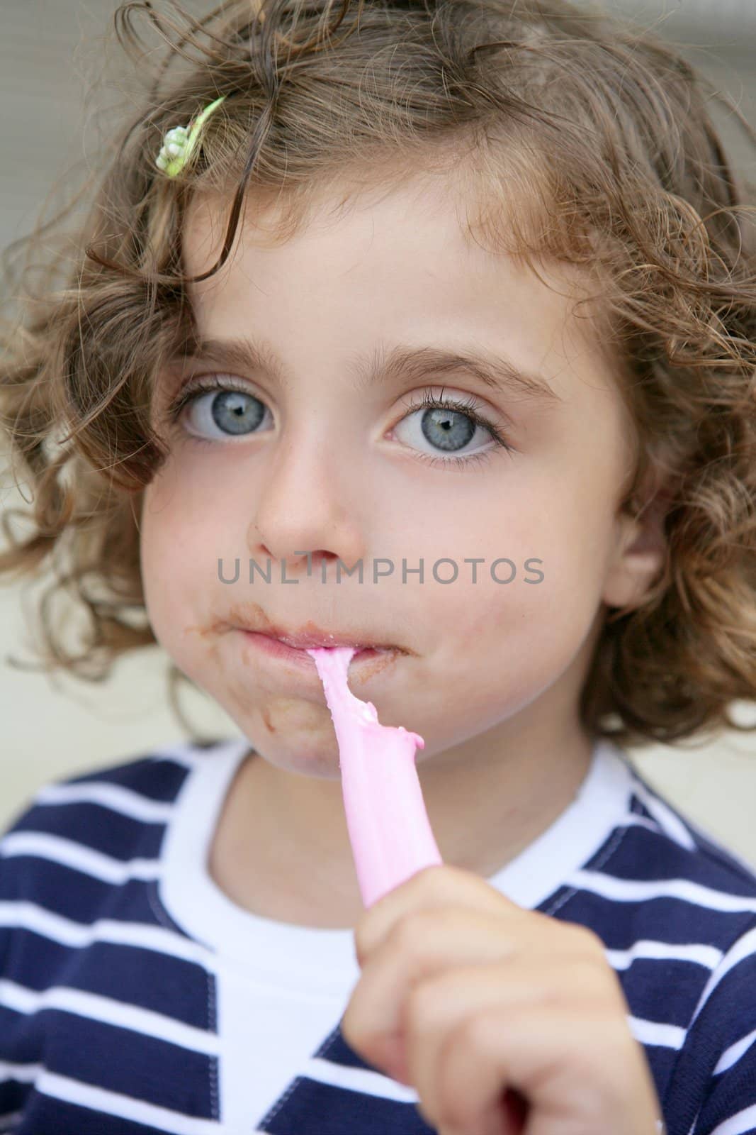 Little girl eating sweet candy with dirty face by lunamarina