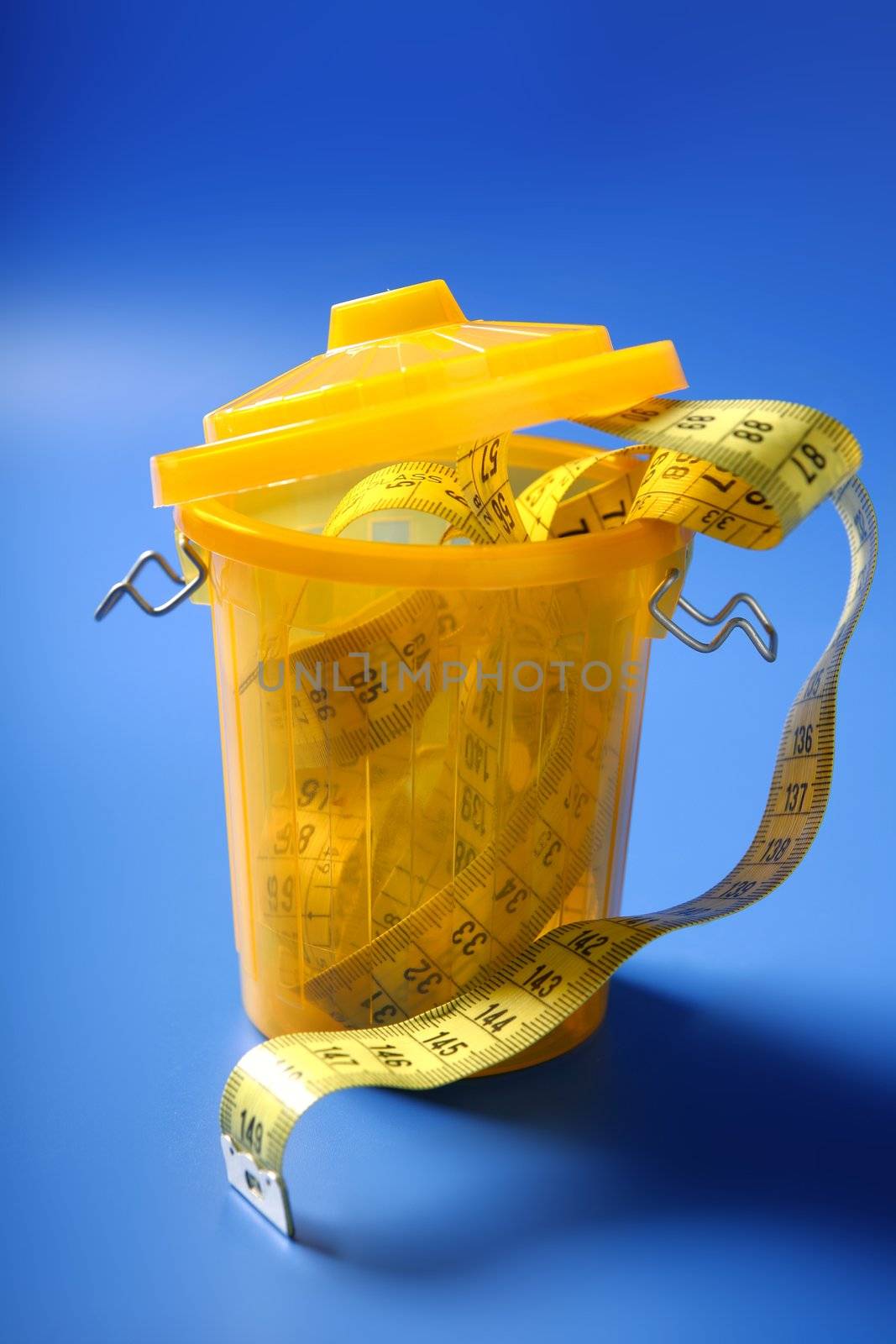 Centimeter tape meter on the trash, end of diet care metaphor