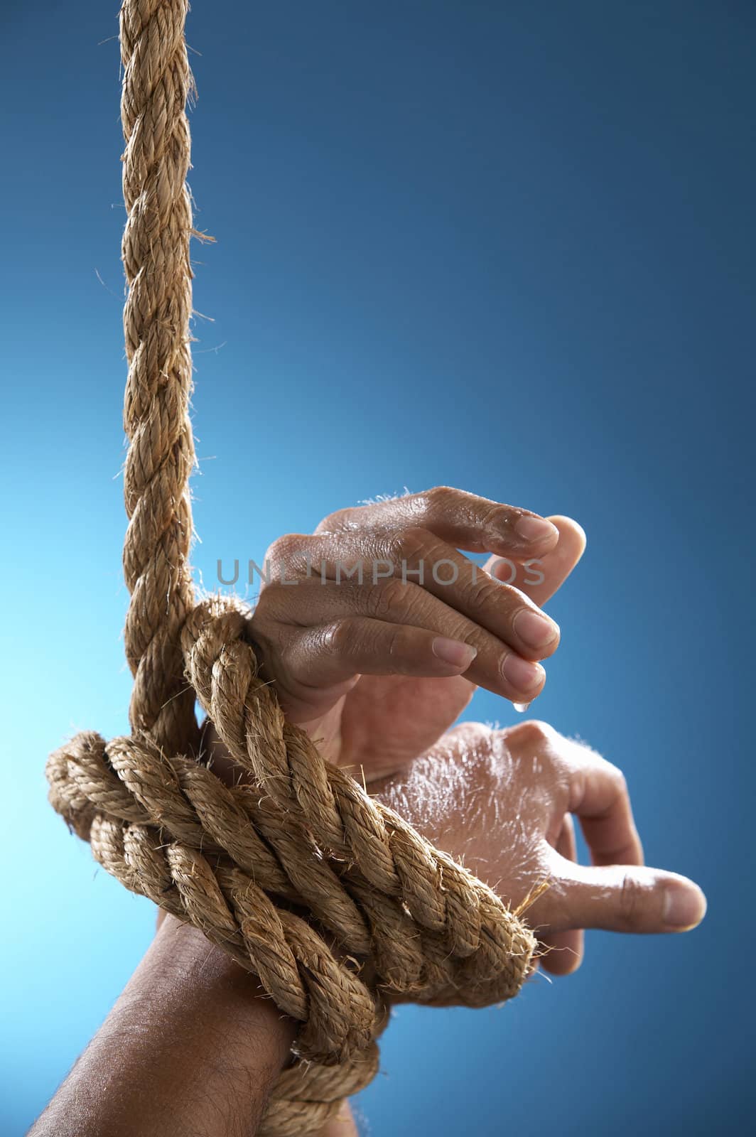 hand being tight by rope asking for help
