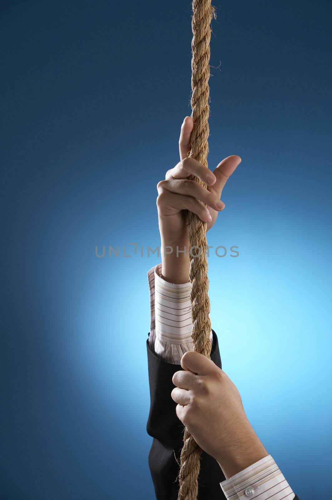 a businessman with suit pulling rope upward