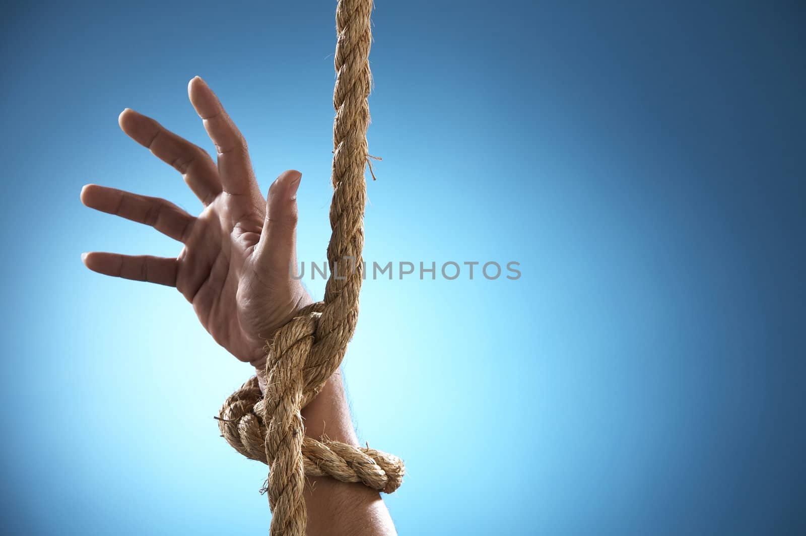 hand being tight by rope asking for help