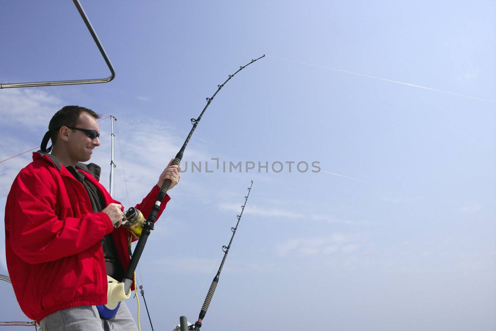 Fisherman fishing on boat big game tuna by lunamarina