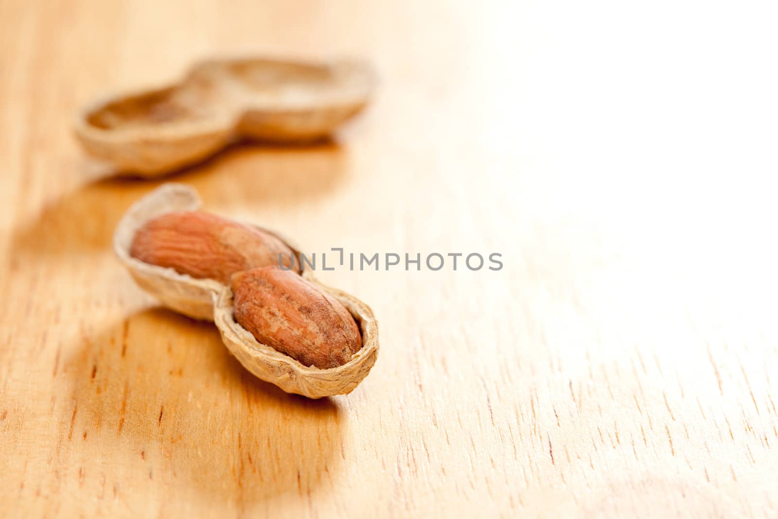 Peanuts on Wood Background with Dramatic Lighting.