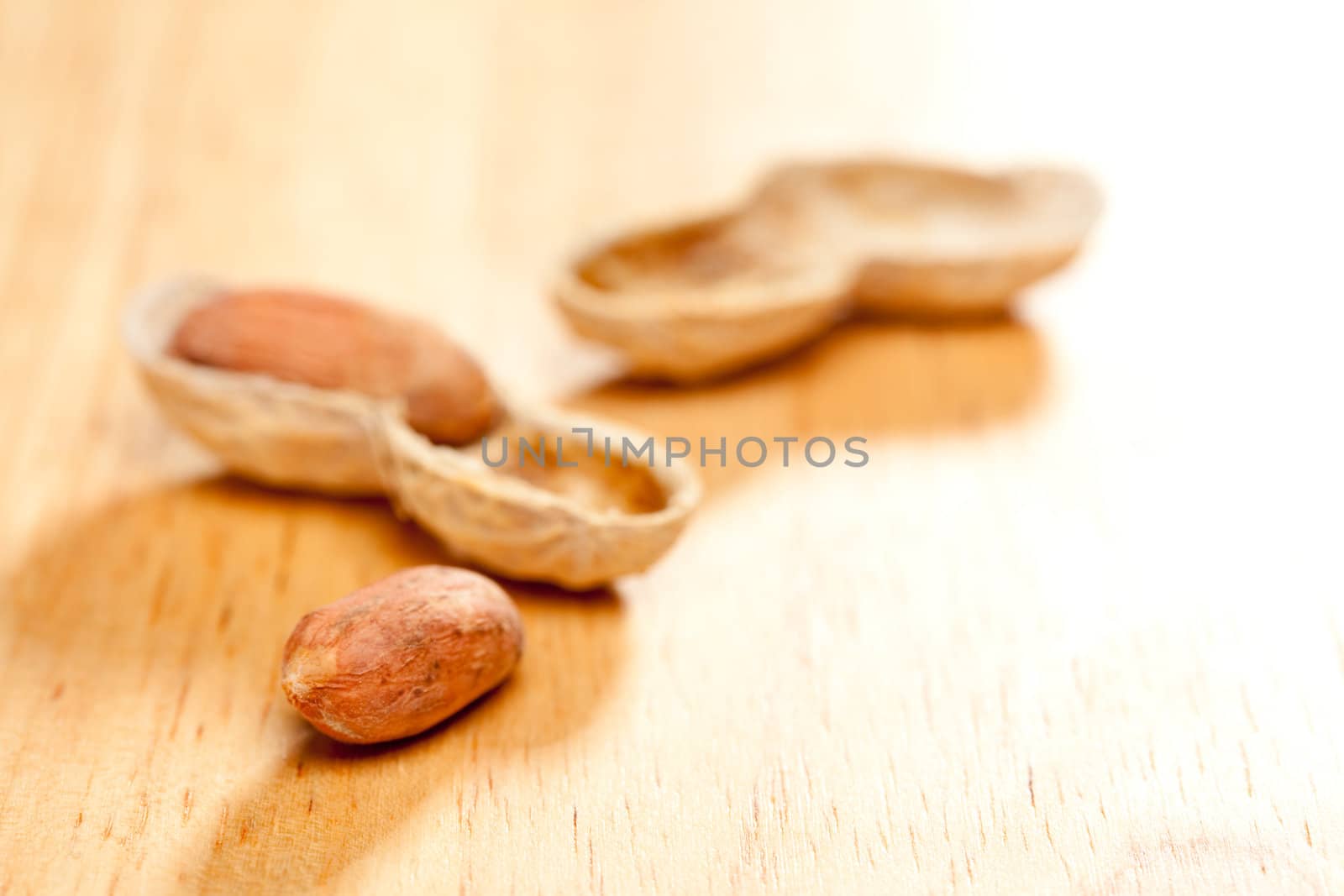 Peanuts on Wood Background with Dramatic Lighting.