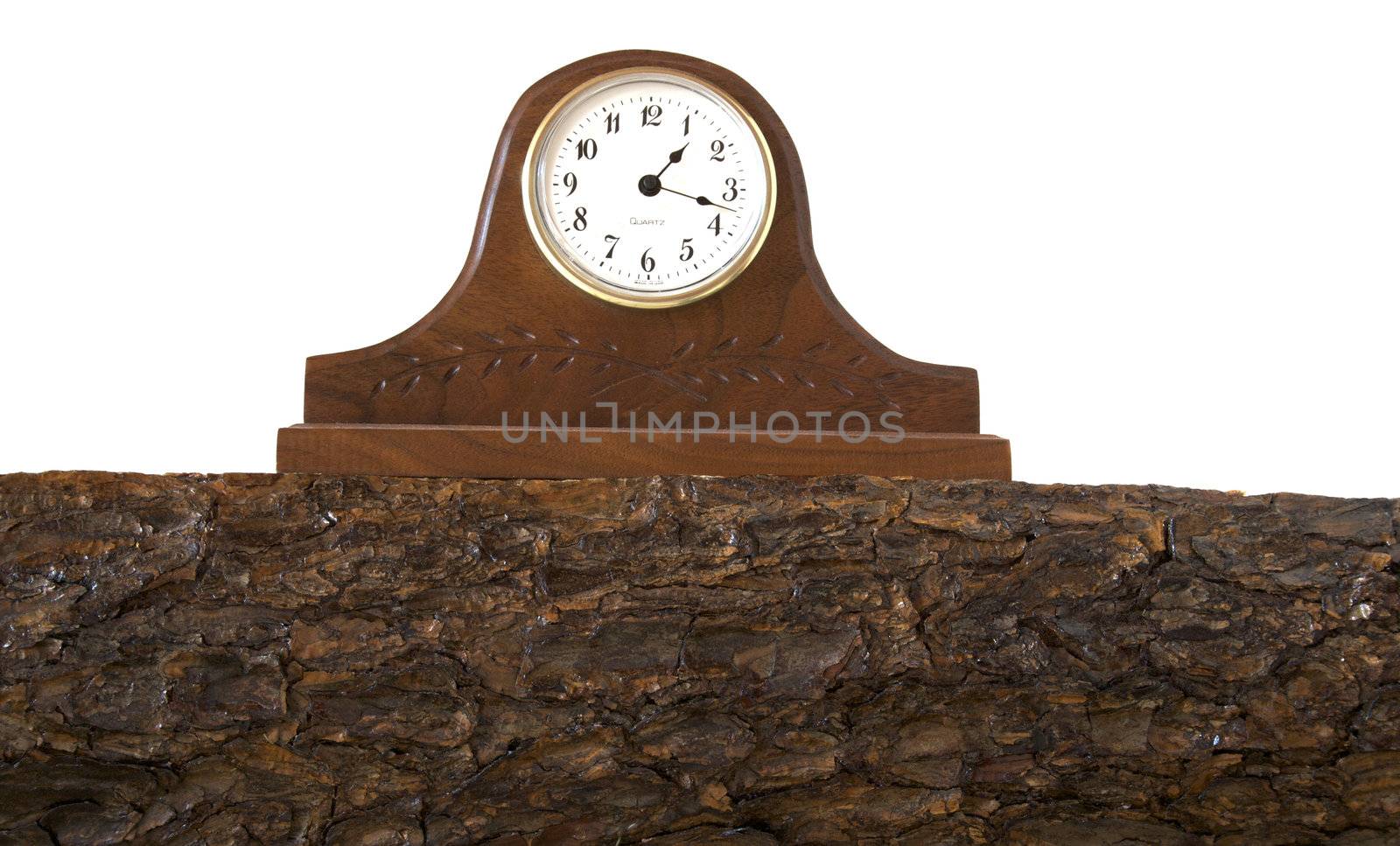A clock sits on top of a hand cut pine mantle.