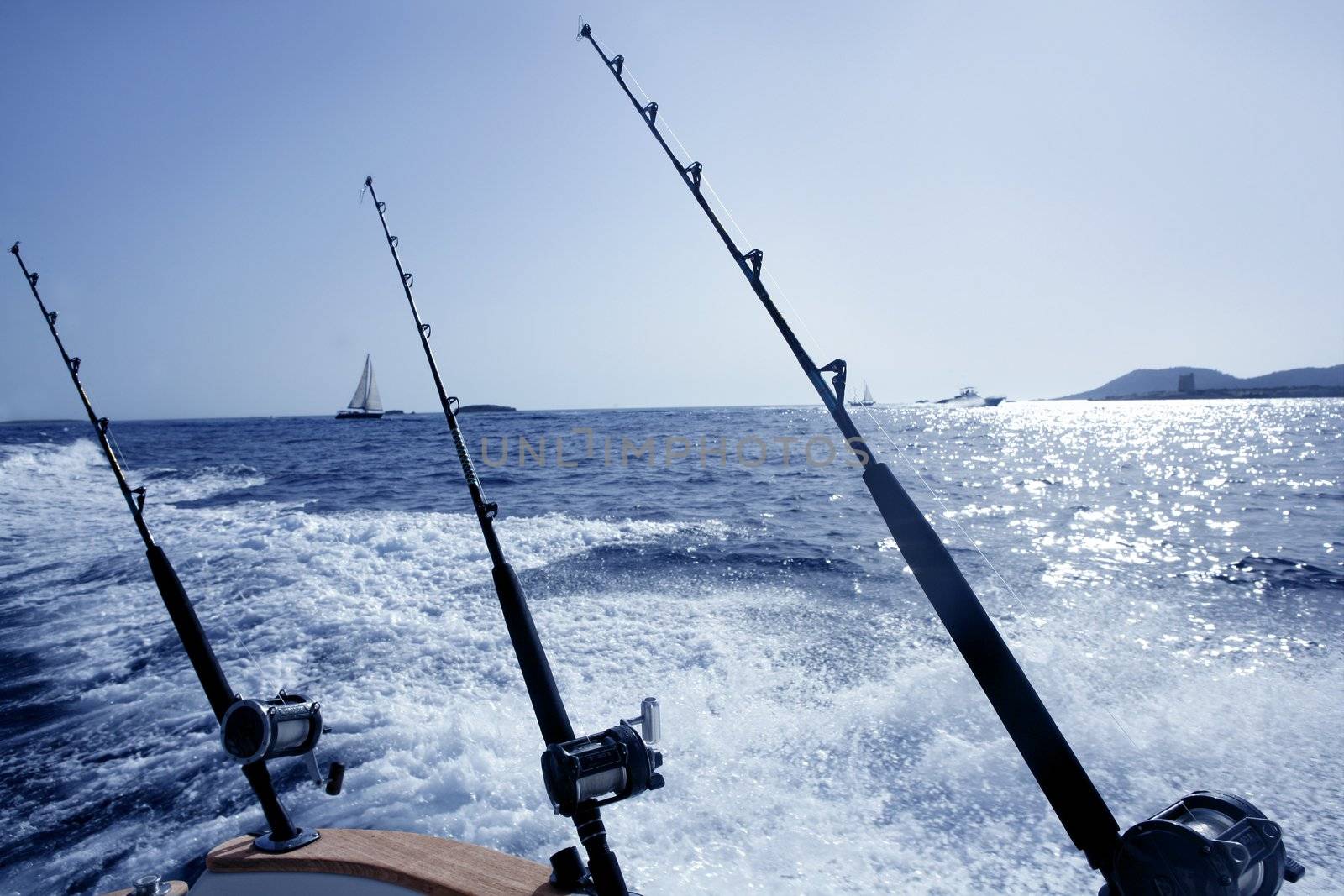 Boat fishing in Mediterranean saltwater with rod and trolling reel