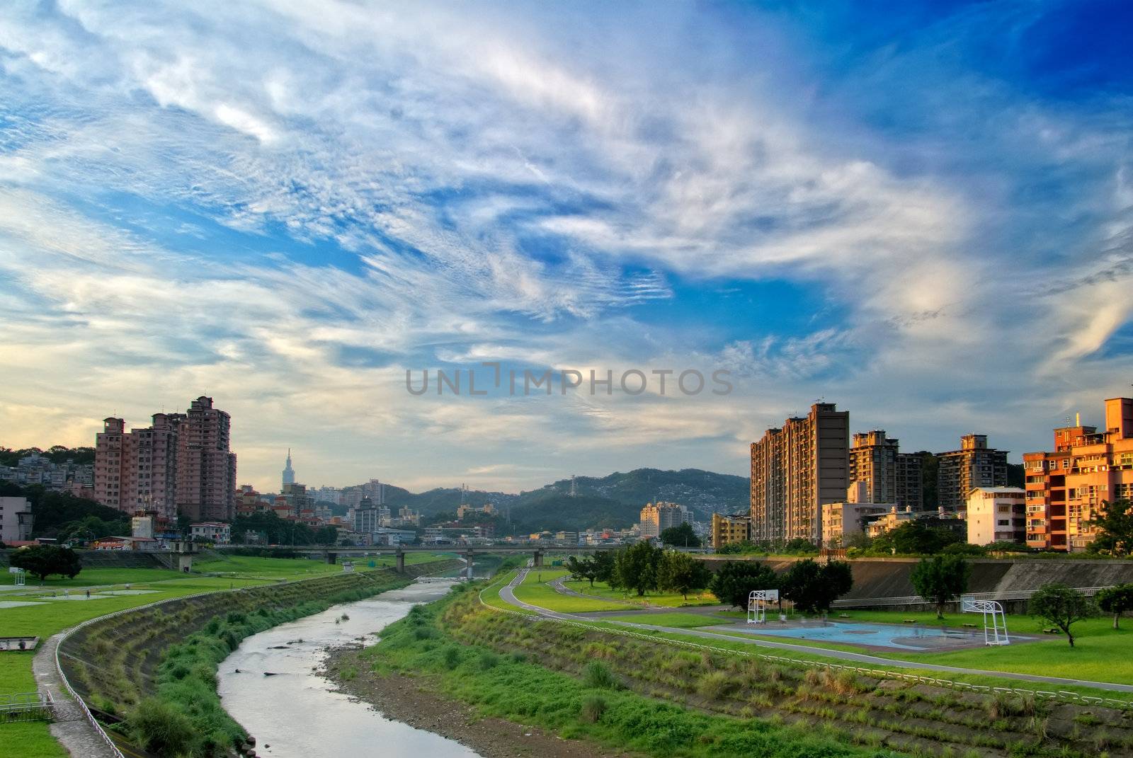 Here is a cityscape of apartment with blue sky.