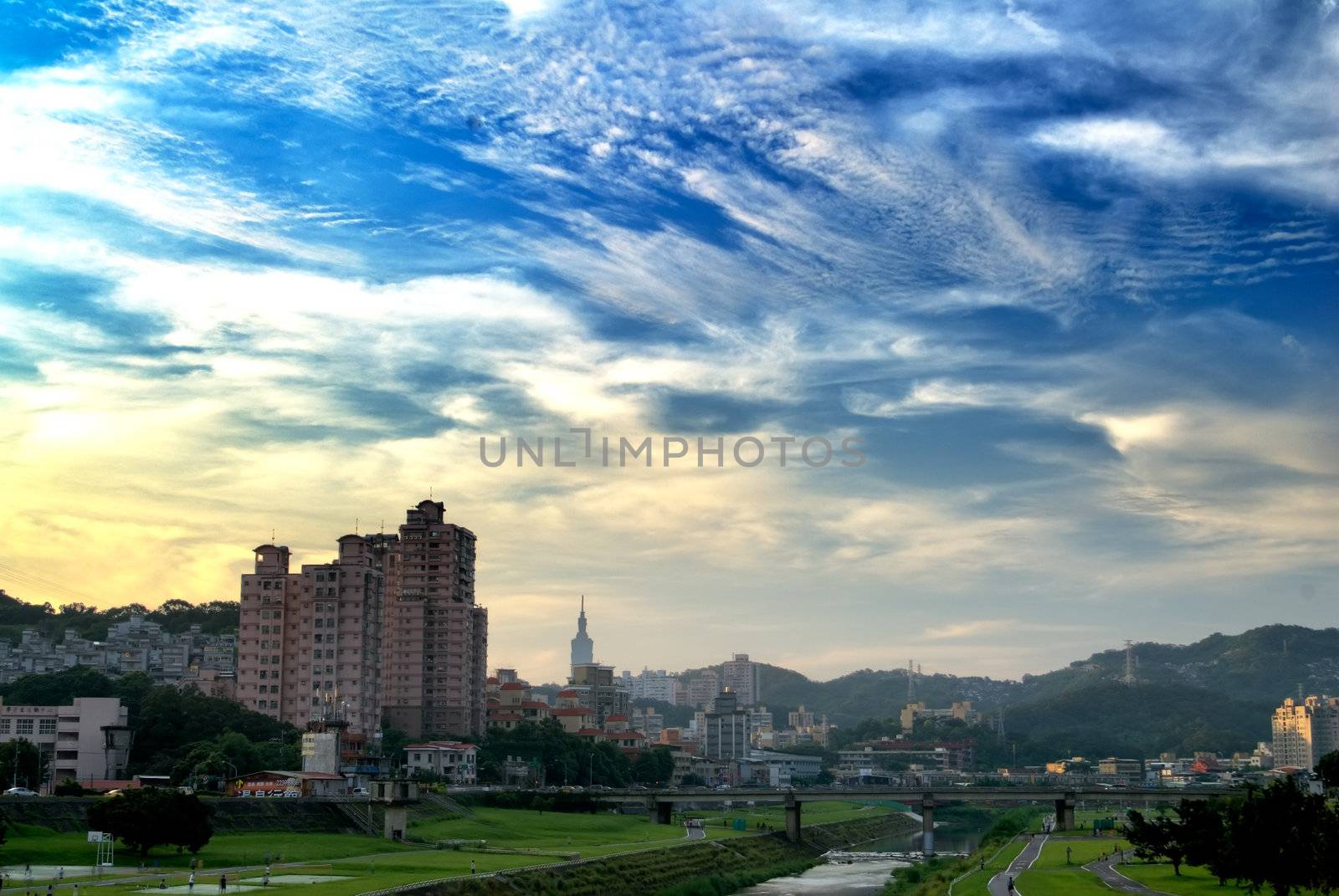 Here is a cityscape of apartment with blue sky.