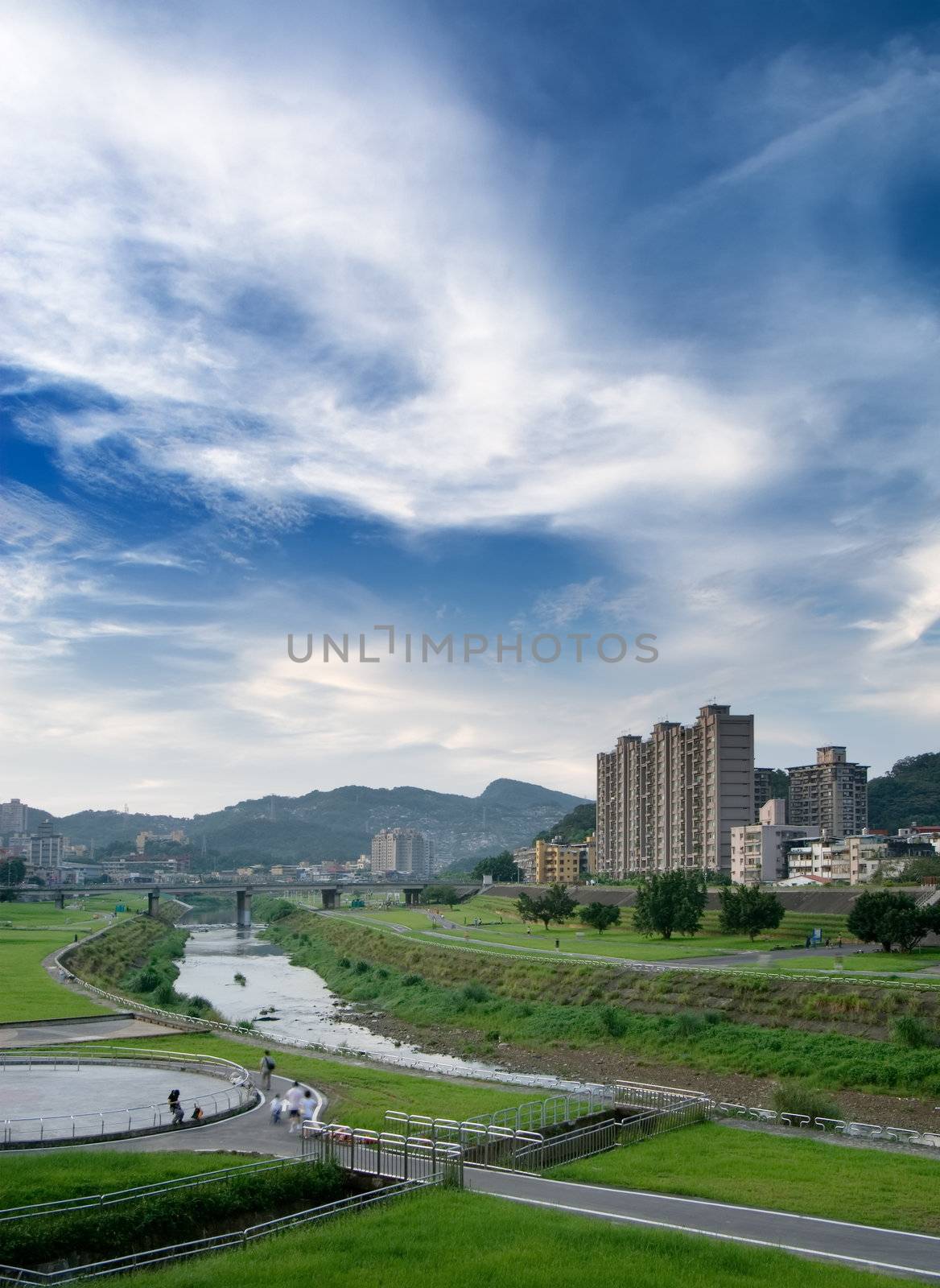 Here is a cityscape of apartment with blue sky.