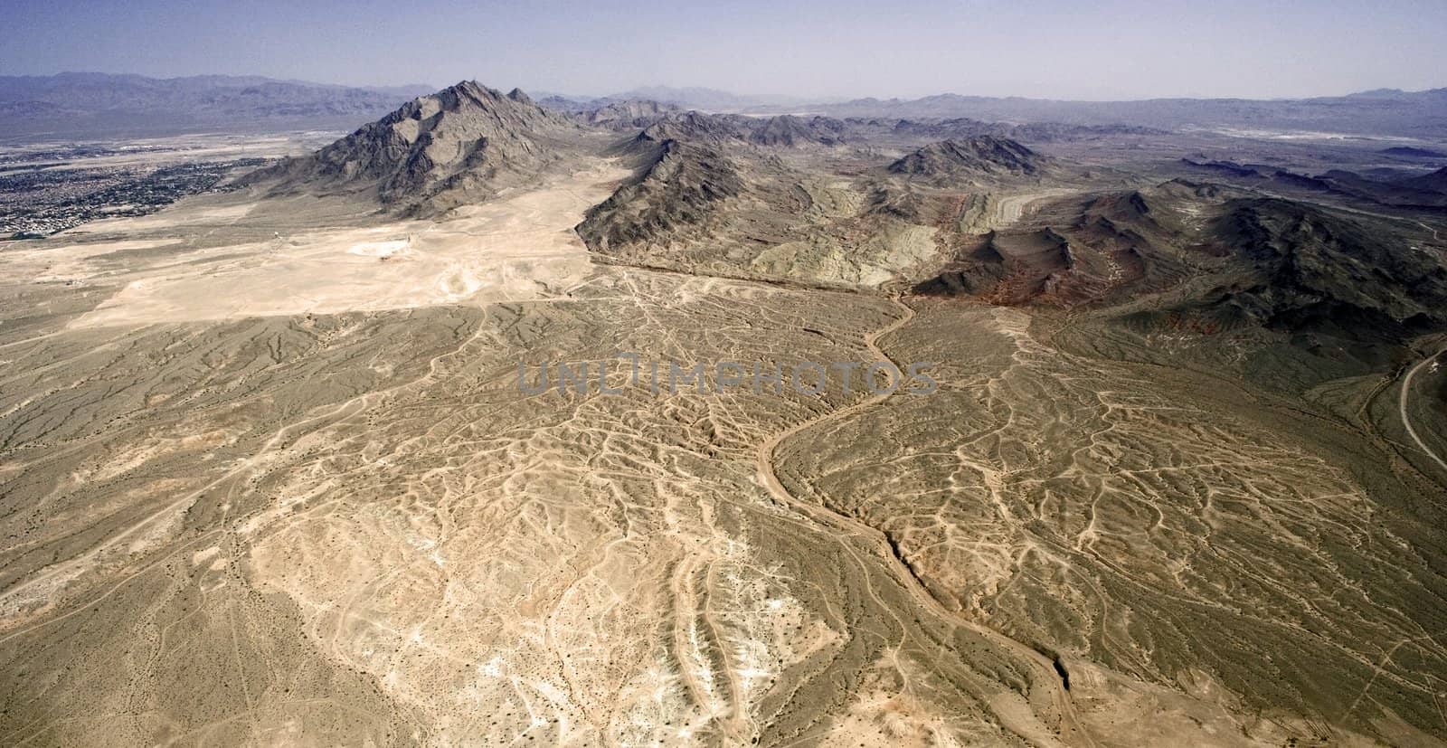 Lifeless dry desert with several picks in a hot weather