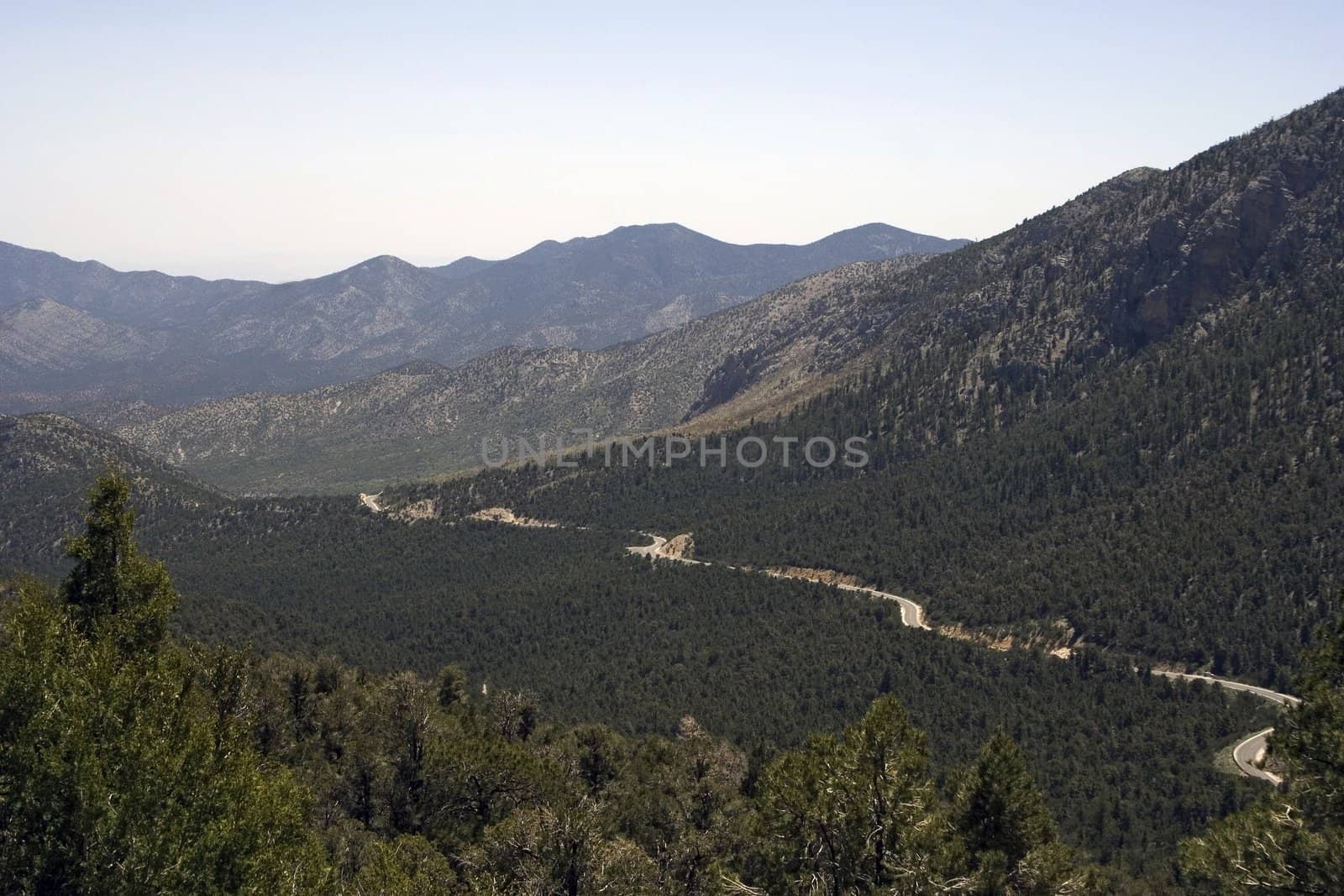 Romantic panorama of the road in the high mountains in a summer day