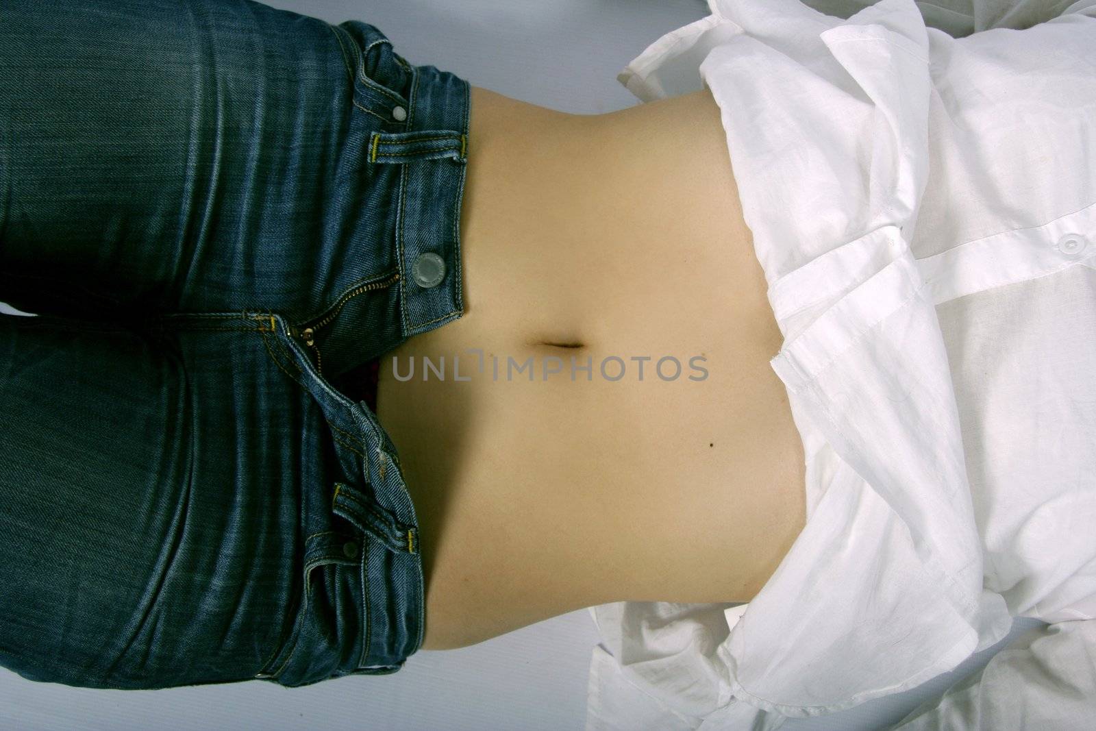 Belly of a pretty woman in jeans