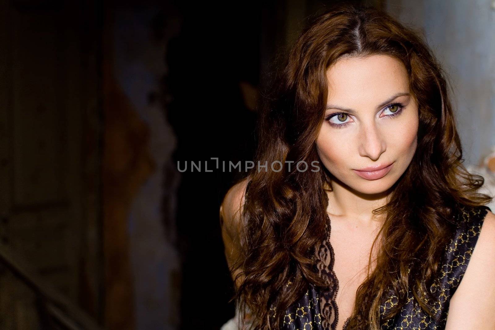 Portrait of glam girl with curly on ruins background