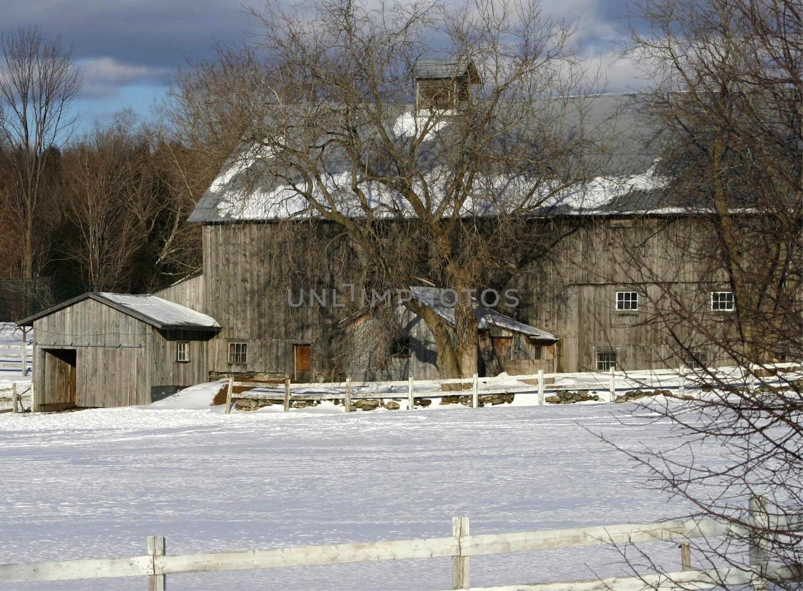 View of a barn surrounded by with winter fields