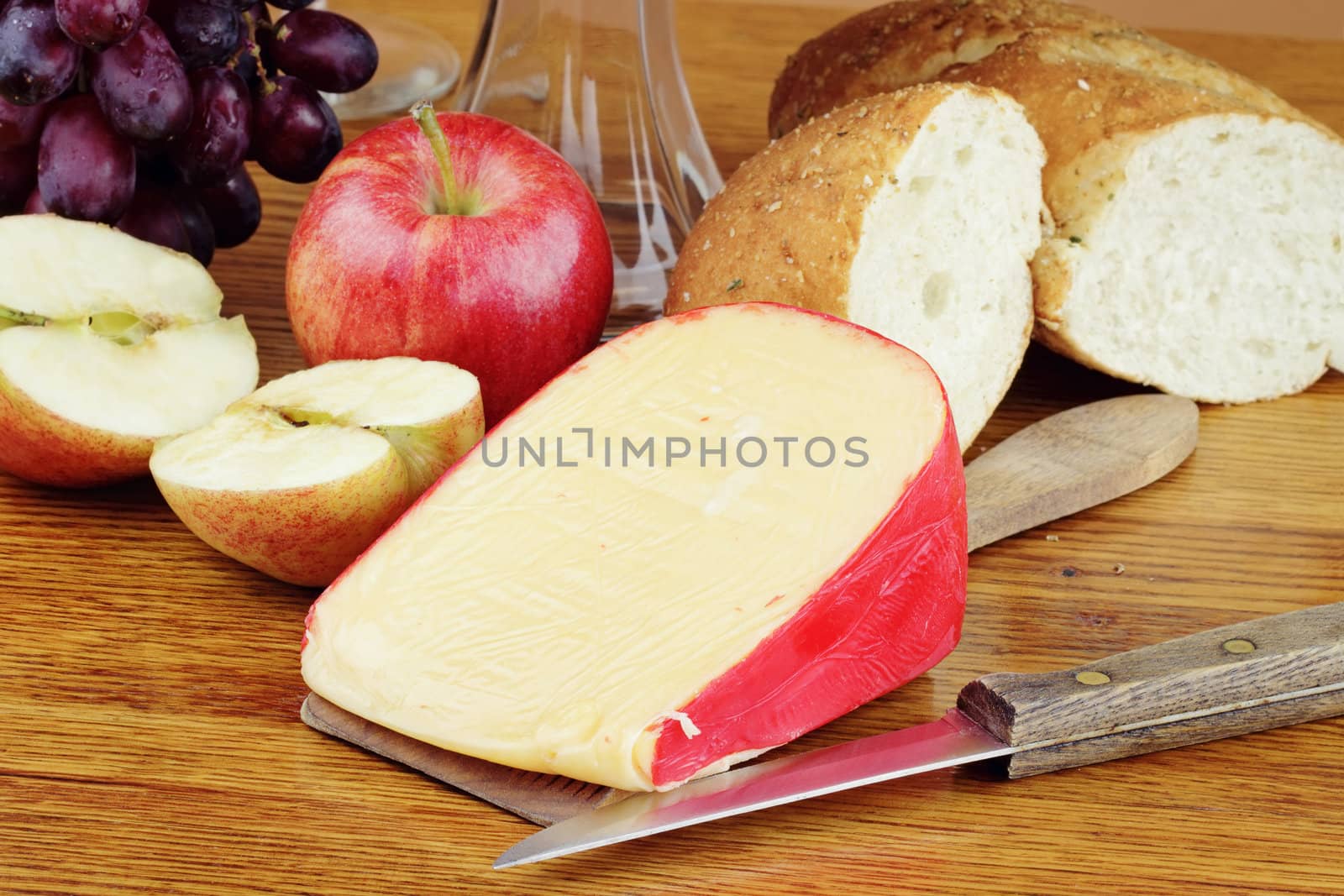 Dutch Edam cheese with fresh fruit and a loaf of bread.