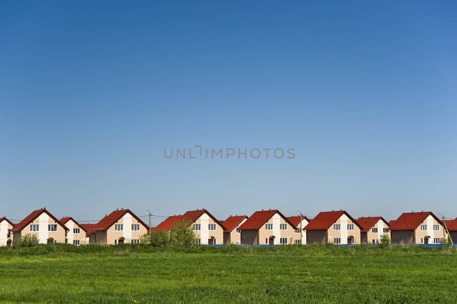 New cottages with red roofs and blue sky