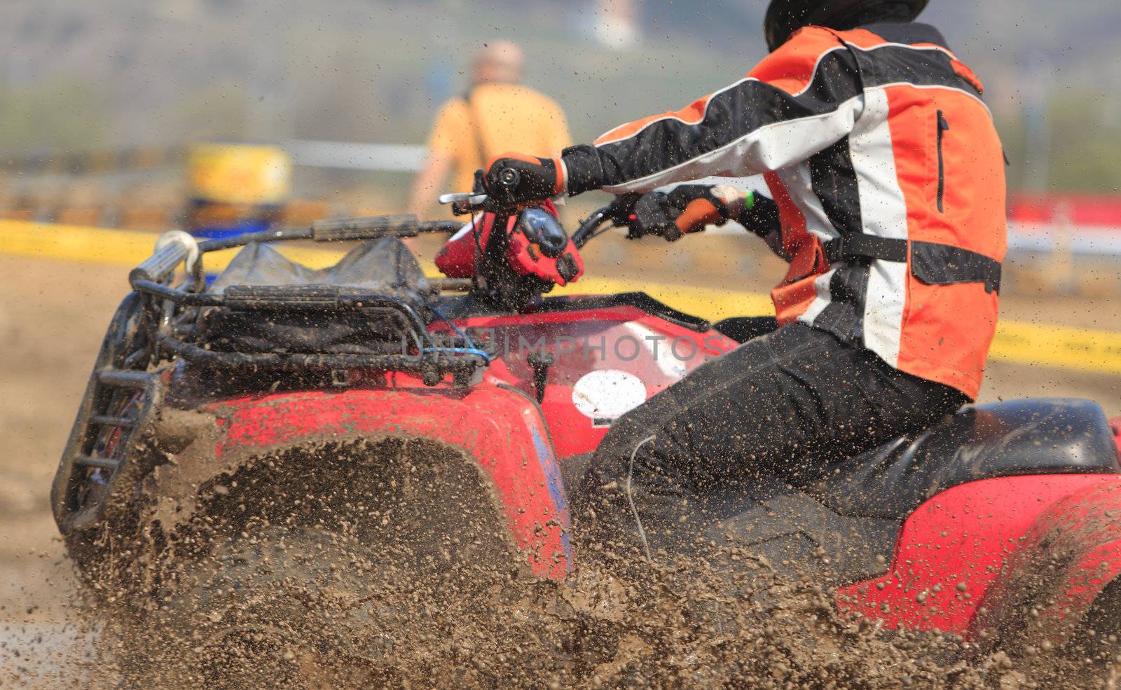 Detail of an ATV during the muddy race.The main focus is on the mud drops.