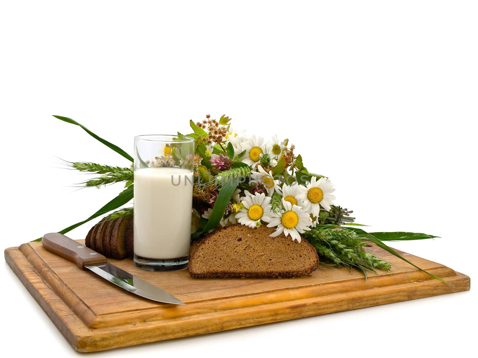Photo of the bread milk and camomile at board against the white background  