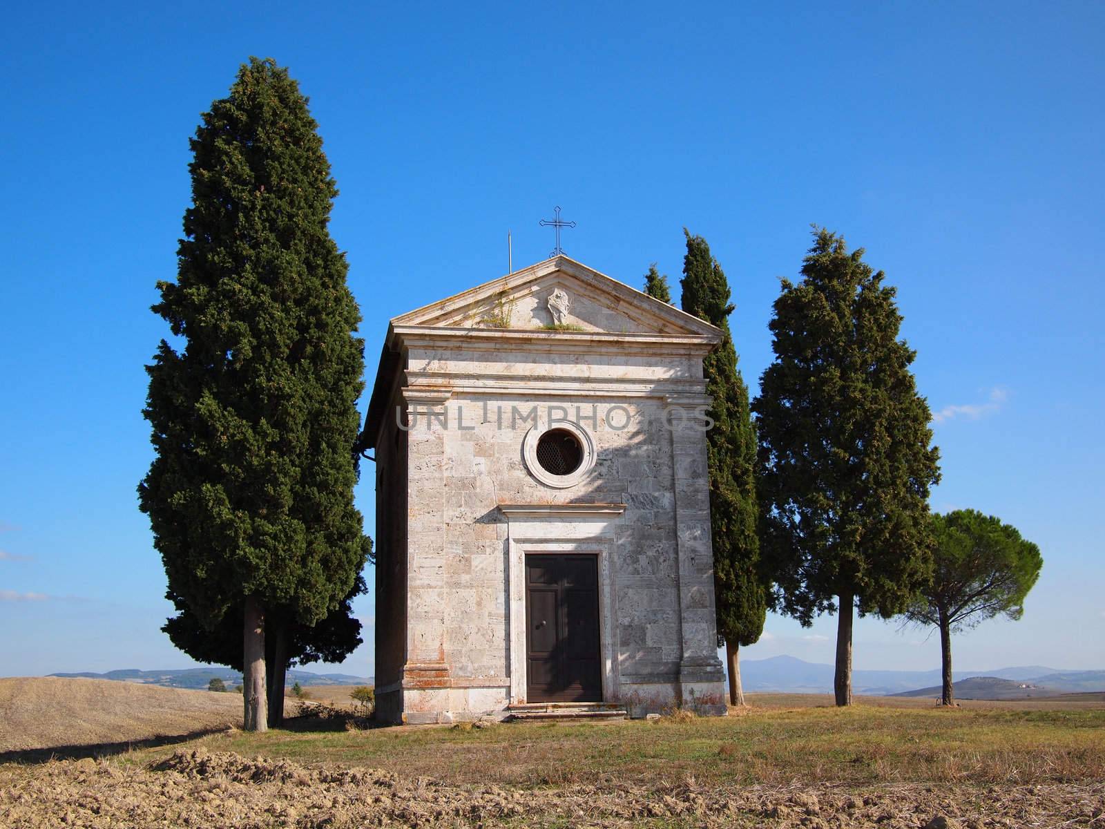 Cappella di Vitaleta with cypresses between San Quirico d'Orcia and Pienza in the Val d'Orcia in Tuscany, Italy.